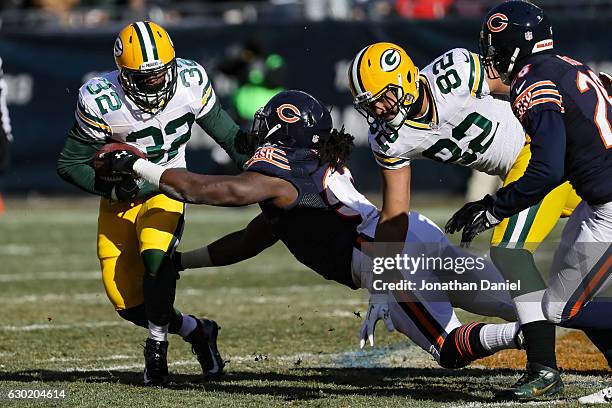 Christine Michael of the Green Bay Packers carries the football against Pernell McPhee of the Chicago Bears in the first quarter at Soldier Field on...