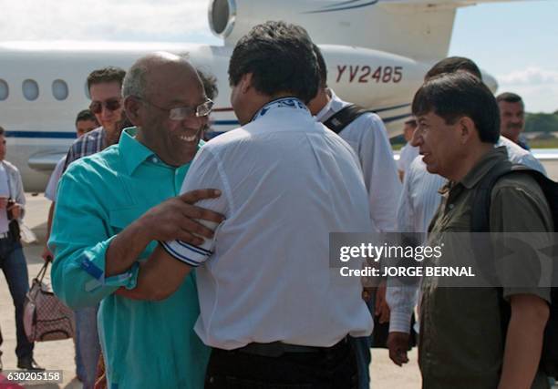 Venezuela's Vice President Aristobulo Isturiz is welcomed by Bolivia's President Evo Morales and Foreign Minister David Choquehuanca upon his arrival...