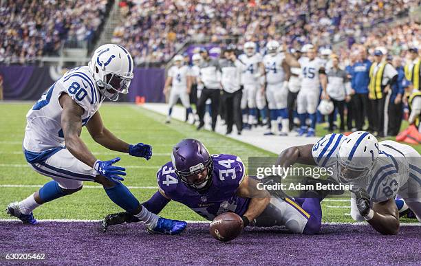 Andrew Sendejo of the Minnesota Vikings, Chester Rogers and Dwayne Allen of the Indianapolis Colts scramble for a loose ball after an incomplete pass...