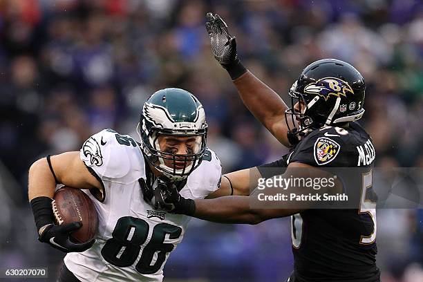 Tight end Zach Ertz of the Philadelphia Eagles carries the ball against outside linebacker Albert McClellan of the Baltimore Ravens in the second...