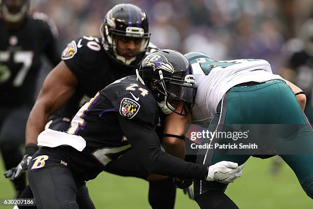 Cornerback Kyle Arrington of the Baltimore Ravens tackles tight end Trey Burton of the Philadelphia Eagles in the first quarter at M&T Bank Stadium...