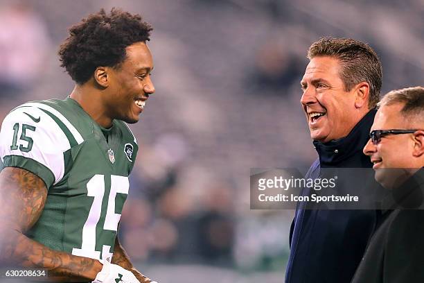 Former Miami Dolphins quarterback Dan Marino talks with New York Jets wide receiver Brandon Marshall on the field prior to the National Football...