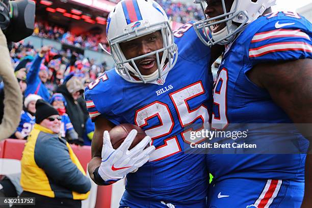 LeSean McCoy of the Buffalo Bills celebrates his touchdown with Jordan Mills of the Buffalo Bills against the Cleveland Browns during the second half...