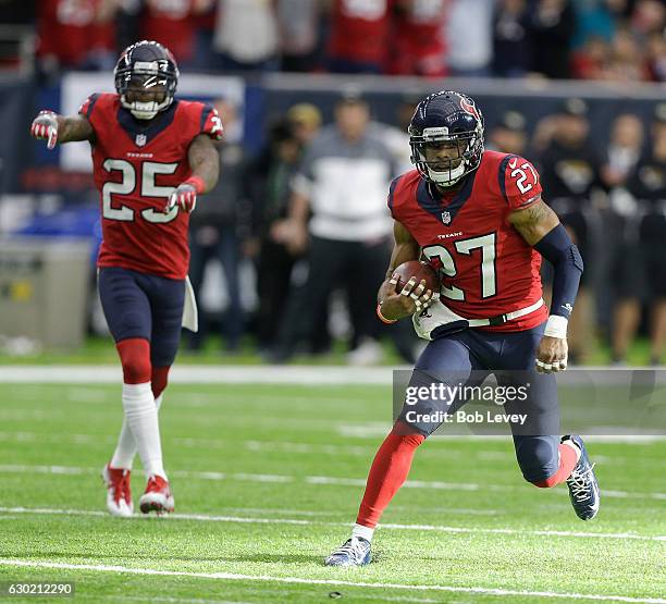 Quintin Demps of the Houston Texans runs with the ball after intercepting a pass in the fourth quarter against the Jacksonville Jaguars as Kareem...