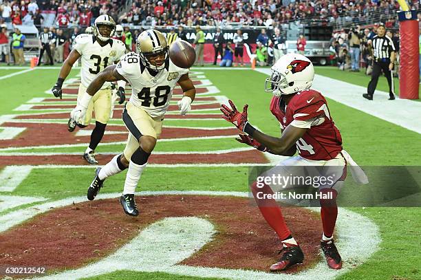 Wide receiver J.J. Nelson of the Arizona Cardinals catches a ten yard touchdown pass in front of free safety Vonn Bell of the New Orleans Saints in...