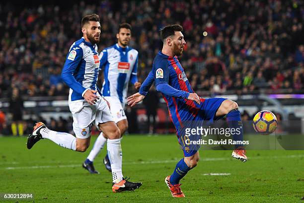 Lionel Messi of FC Barcelona scores his team's fourth goal during the La Liga match between FC Barcelona and RCD Espanyol at the Camp Nou stadium on...