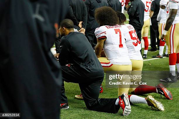 Colin Kaepernick of the San Francisco 49ers and Eli Harold kneel during the National Anthem prior to the game against the Atlanta Falcons at the...