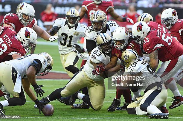 Outside linebacker Craig Robertson of the New Orleans Saints recovers the football fumbled by wide receiver Larry Fitzgerald of the Arizona Cardinals...