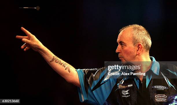 Phil Taylor of England throws during his first round match against David Platt of England during Day Four of the 2017 William Hill PDC World Darts...