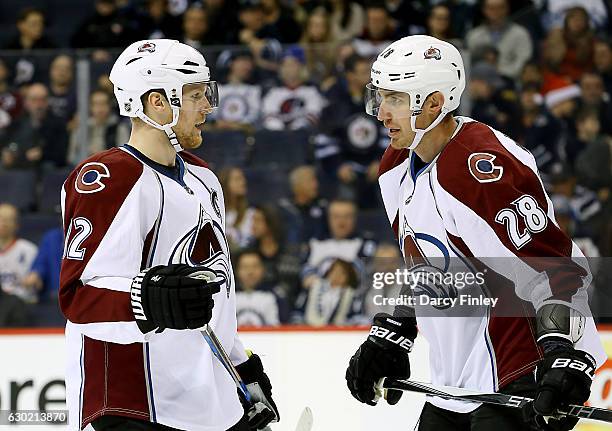 Gabriel Landeskog and Patrick Wiercioch of the Colorado Avalanche discuss strategy during a first period stoppage in play against the Winnipeg Jets...