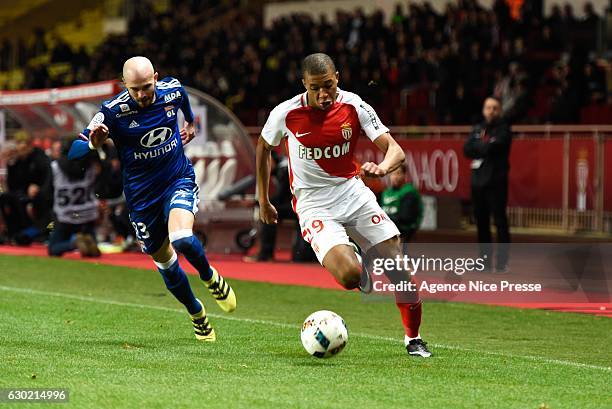 Christophe Jallet of Lyon and Kylian Mbappe of Monaco during the French Ligue 1 match between Monaco and Lyon at Louis II Stadium on December 18,...