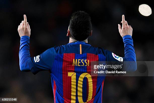 Lionel Messi of FC Barcelona celebrates after scoring his team's fourth goal during the La Liga match between FC Barcelona and RCD Espanyol at the...