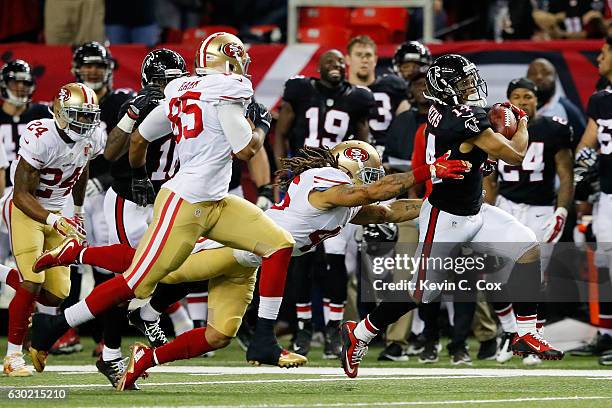 Eric Weems of the Atlanta Falcons is tackled by Marcus Ball of the San Francisco 49ers during the first half at the Georgia Dome on December 18, 2016...