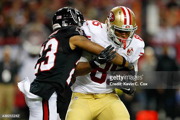 Robert Alford of the Atlanta Falcons tackles Je'Ron Hamm of the San Francisco 49ers during the first half at the Georgia Dome on December 18, 2016 in...