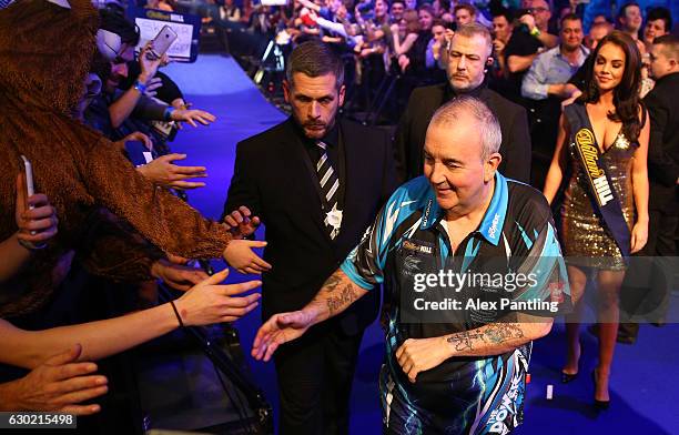 Phil Taylor of England greets supporters prior to his first round match against David Platt of England during Day Four of the 2017 William Hill PDC...