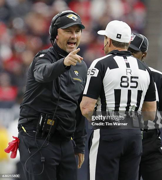 Head coach Gus Bradley of the Jacksonville Jaguars argures a call with referee Ed Hochuli in the fourth quarter durng the game against the Houston...