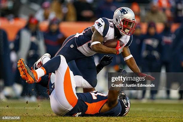 Running back Dion Lewis of the New England Patriots is tackled by inside linebacker Corey Nelson of the Denver Broncos at Sports Authority Field at...