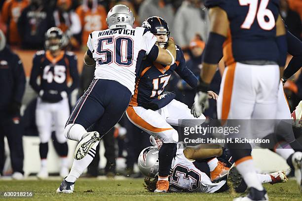 Jabaal Sheard of the New England Patriots and Rob Ninkovich tackle Trevor Siemian of the Denver Broncos during the fourth quarter of the Patriots'...