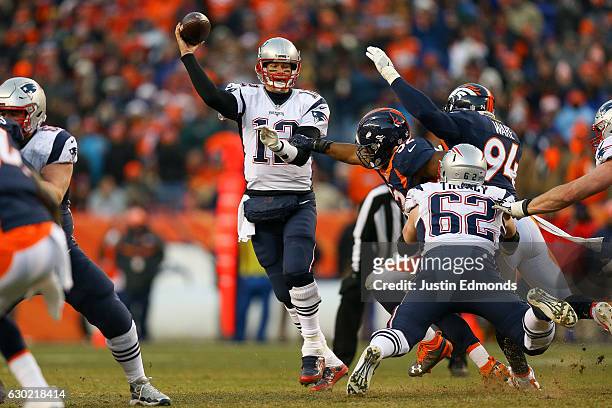 Quarterback Tom Brady of the New England Patriots passes under pressure by inside linebacker Corey Nelson of the Denver Broncos in the third quarter...
