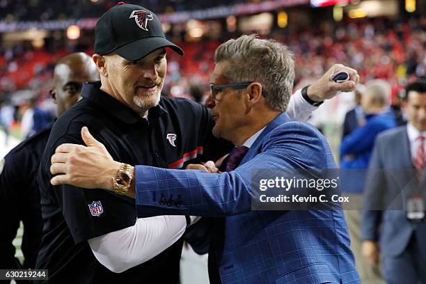 Head coach Dan Quinn of the Atlanta Falcons shakes hands with general manager, Thomas Dimitroff, after beating the San Francisco 49ers at the Georgia...