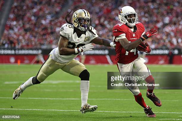 Wide receiver J.J. Nelson of the Arizona Cardinals runs with the football after a reception in front of cornerback B.W. Webb of the New Orleans...