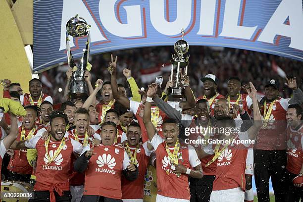 Players of Santa Fe lift the trophy after a second leg final match between Santa Fe and Deportes Tolima as part of Liga Aguila II 2016 at El Campin...
