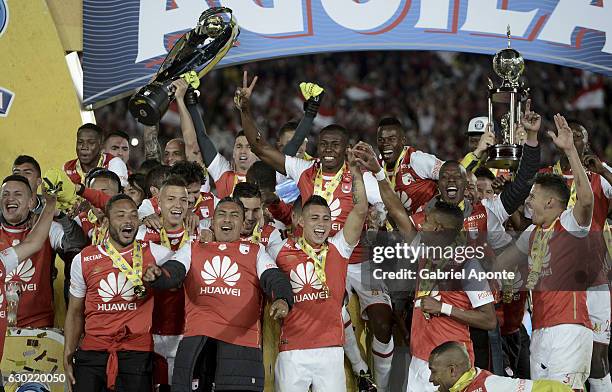 Players of Santa Fe lift the trophy after a second leg final match between Santa Fe and Deportes Tolima as part of Liga Aguila II 2016 at El Campin...