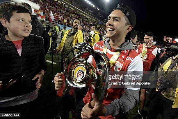 Kevin Salazar of Santa Fe holds the trophy to celebrate after winning a second leg final match between Santa Fe and Deportes Tolima as part of Liga...