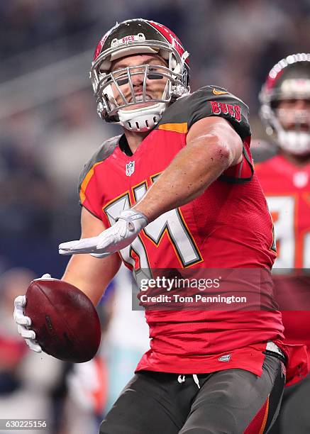 Cameron Brate of the Tampa Bay Buccaneers celebrates after catching a pass from Jameis Winston during the third quarter against the Dallas Cowboys at...