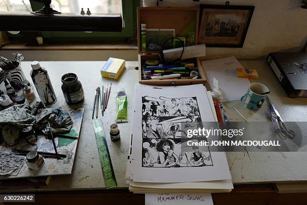 View of German cartoonist and comics author Reinhard Kleist's desk in his studio in Berlin on November 23, 2016. Berlin now sees flourish the stories...