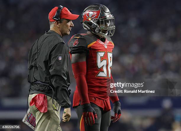 Head coach Dirk Koetter talks with Kwon Alexander of the Tampa Bay Buccaneers on the sideline during the second half against the Dallas Cowboys at...