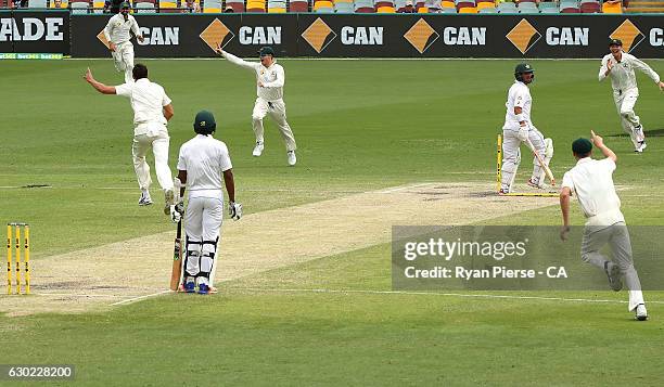 Steve Smith of Australia celebrates after running out Yasir Shah of Pakistan to claim victory during day five of the First Test match between...