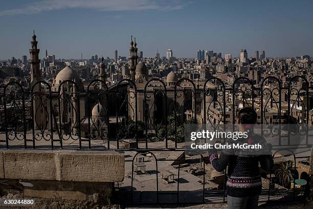 Young girl looks out over the Cairo skyline on December 16, 2016 in Cairo, Egypt. Since the 2011 Arab Spring, Egyptians have been facing a crisis,...