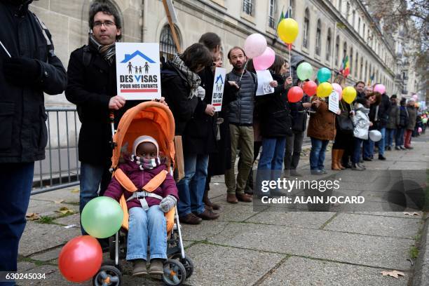 Families waiting to adopt children from the Democratic Republic of Congo demonstrate at the Mission d'adoption internationale headquarters in Paris...