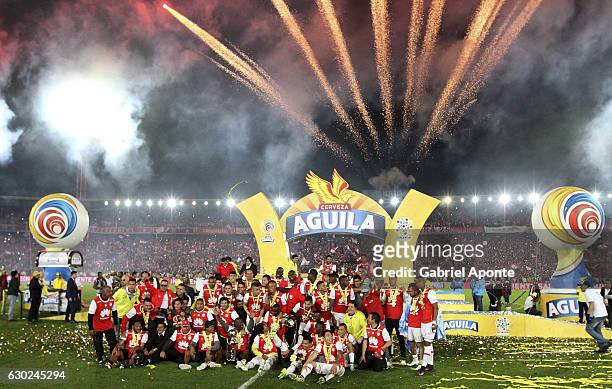 Players of Santa Fe celebrate with the trophy after a second leg final match between Santa Fe and Deportes Tolima as part of Liga Aguila II 2016 at...