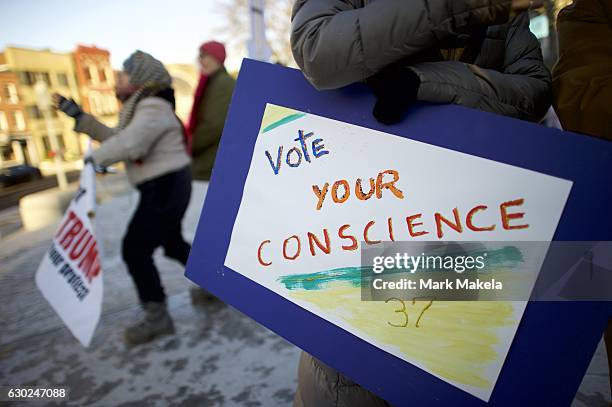 Donald Trump protestors demonstrate outside the Pennsylvania Capitol Building before electors arrive to cast their votes from the election at...