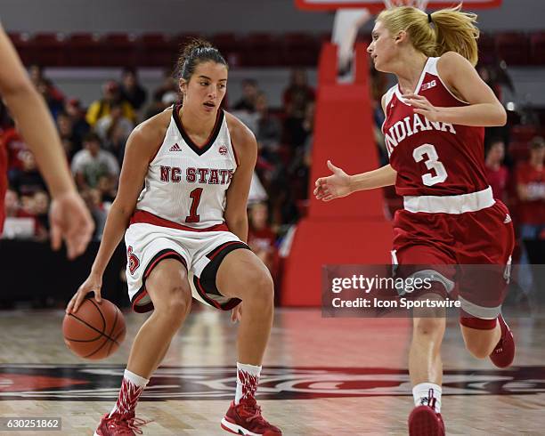 North Carolina State Wolfpack guard Aislinn Konig dribbles behind her back to advance up the court during the second half of the ACC/Big10 Challenge...