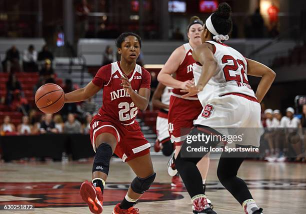 Indiana Hoosiers guard Tia Elbert begins a drive around North Carolina State Wolfpack guard Dominique Wilson during the second half of the ACC/Big10...