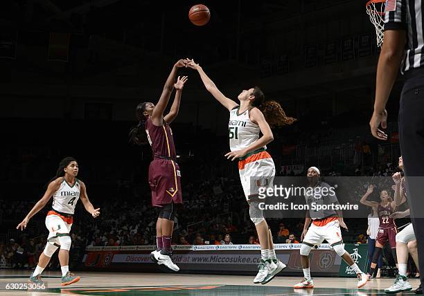 Miami center Serena-Lynn Geldof defends against the shot of Loyola guard/forward Brandi Segars during an NCAA basketball game between Loyola Chicago...