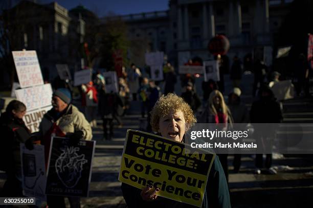 Esther Gordon, joins protestors demonstrating outside the Pennsylvania Capitol Building before electors arrive to cast their votes from the election...