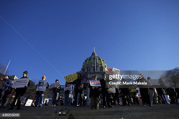 Donald Trump protestors demonstrate outside the Pennsylvania Capitol Building before electors arrive to cast their votes from the election at...