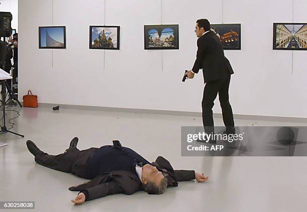 Graphic content / This picture taken on December 19, 2016 shows Andrei Karlov , the Russian ambassador to Ankara, lying on the floor after being shot...