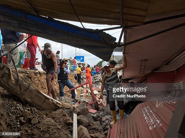 In Tonsupa coastal zone of the province of Emeraldas, residents try to rescue their belongings after the swarm of earthquakes, in Tonsupa, Monday...