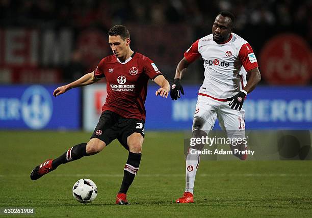 Georg Margreitter of 1. FC Nuernberg is challenged by Jacques Zoua Daogari of 1. FC Kaiserslautern during the Second Bundesliga match between 1. FC...