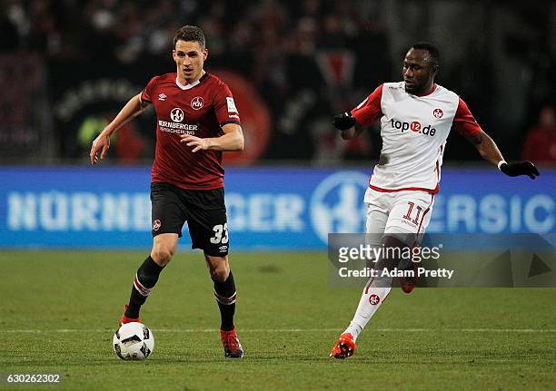 Georg Margreitter of 1. FC Nuernberg is challenged by Jacques Zoua Daogari of 1. FC Kaiserslautern during the Second Bundesliga match between 1. FC...