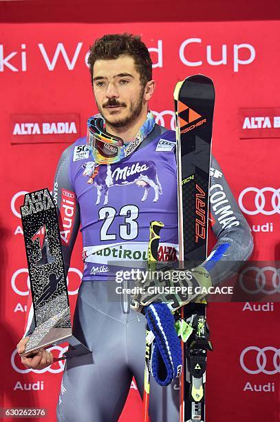 France's Cyprien Sarrazin poses on the podium after winning the Men's Parallel Giant Slalom at the FIS Alpine World Cup in Alta Badia in the Italian...