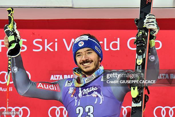 France's Cyprien Sarrazin celebrates on the podium after winning the Men's Parallel Giant Slalom at the FIS Alpine World Cup in Alta Badia in the...