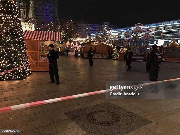 Police take security measures after a truck plough into a crowd at a Christmas market site in Berlin, Germany on December 19, 2016. Several injuries...