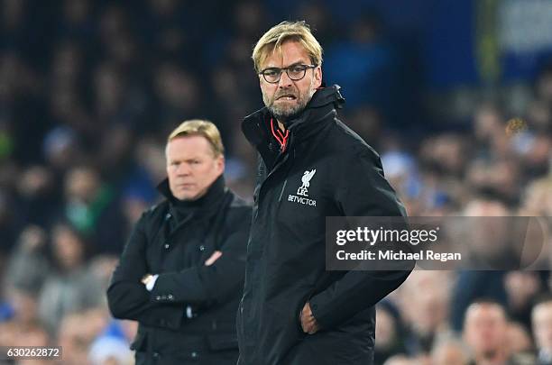 Jurgen Klopp manager of Liverpool reacts as Ronald Koeman manager of Everton looks on during the Premier League match between Everton and Liverpool...