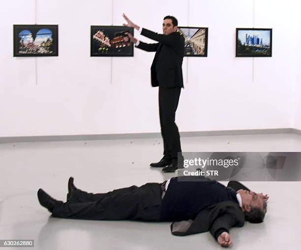 Graphic content / This picture taken on December 19, 2016 shows Andrei Karlov , the Russian ambassador to Ankara, lying on the floor after being shot...